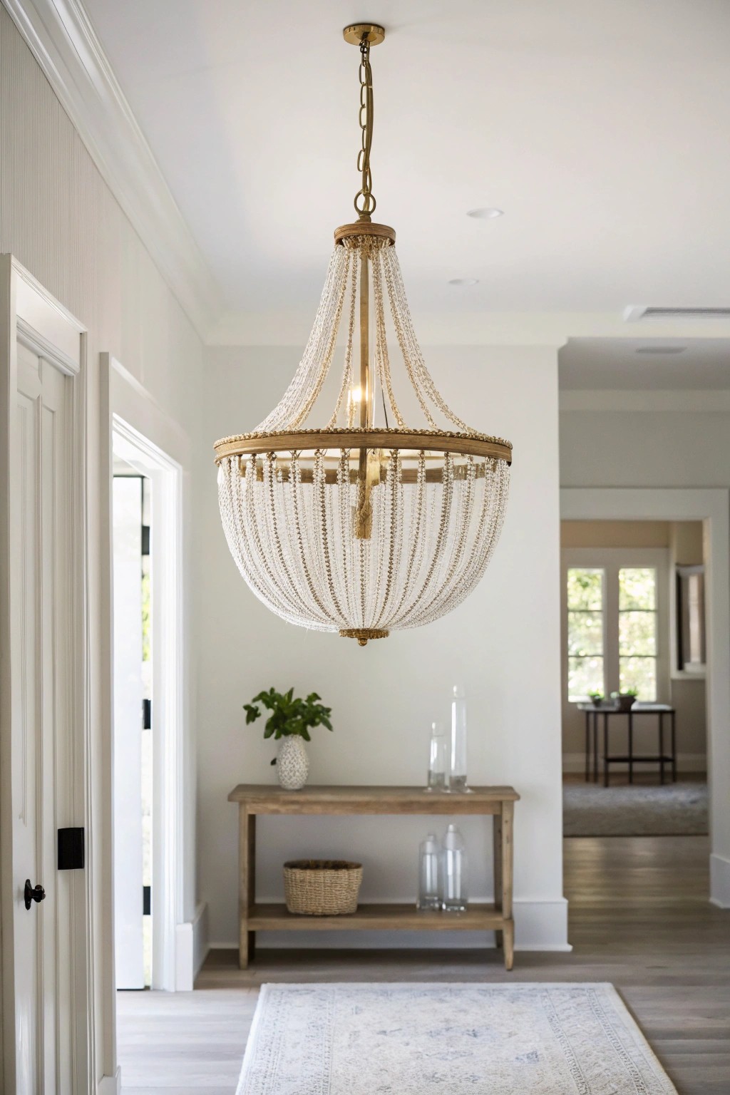 Let your entryway shine with a statement chandelier—where artistry meets simplicity.