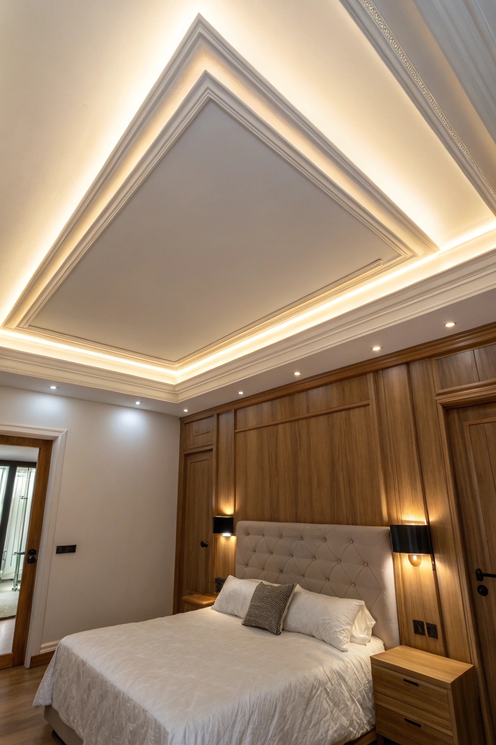 Serene bedroom ceiling with hidden LED cove lighting for a cozy, crafted glow.