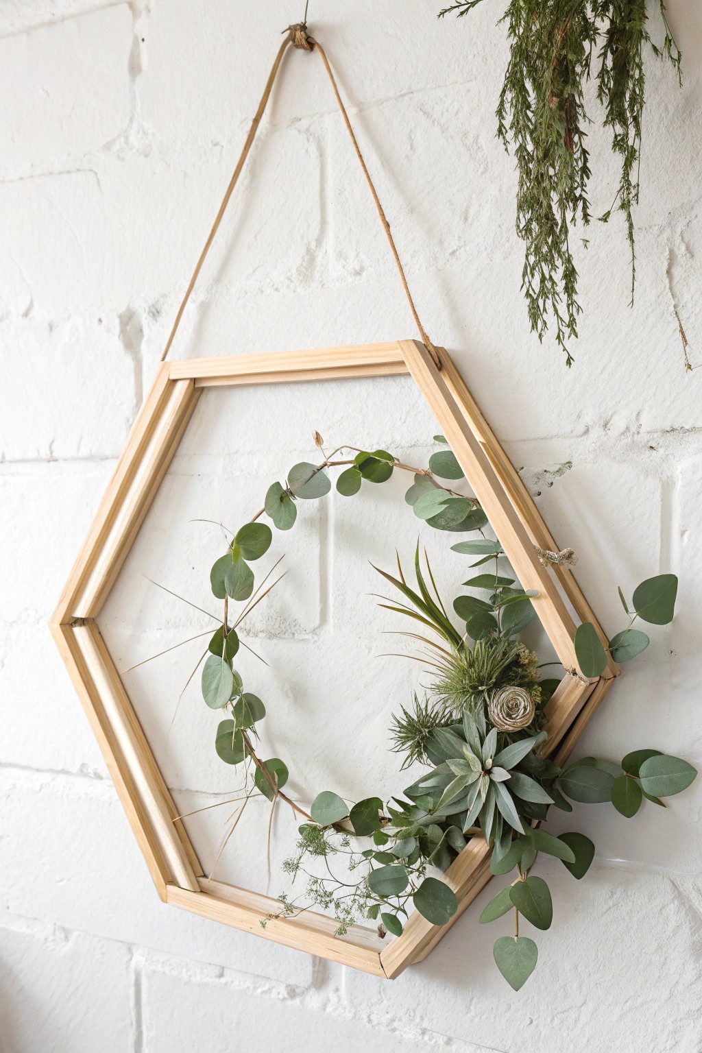 Chic minimalism: a geometric wooden wreath with fresh greenery for a modern holiday touch.