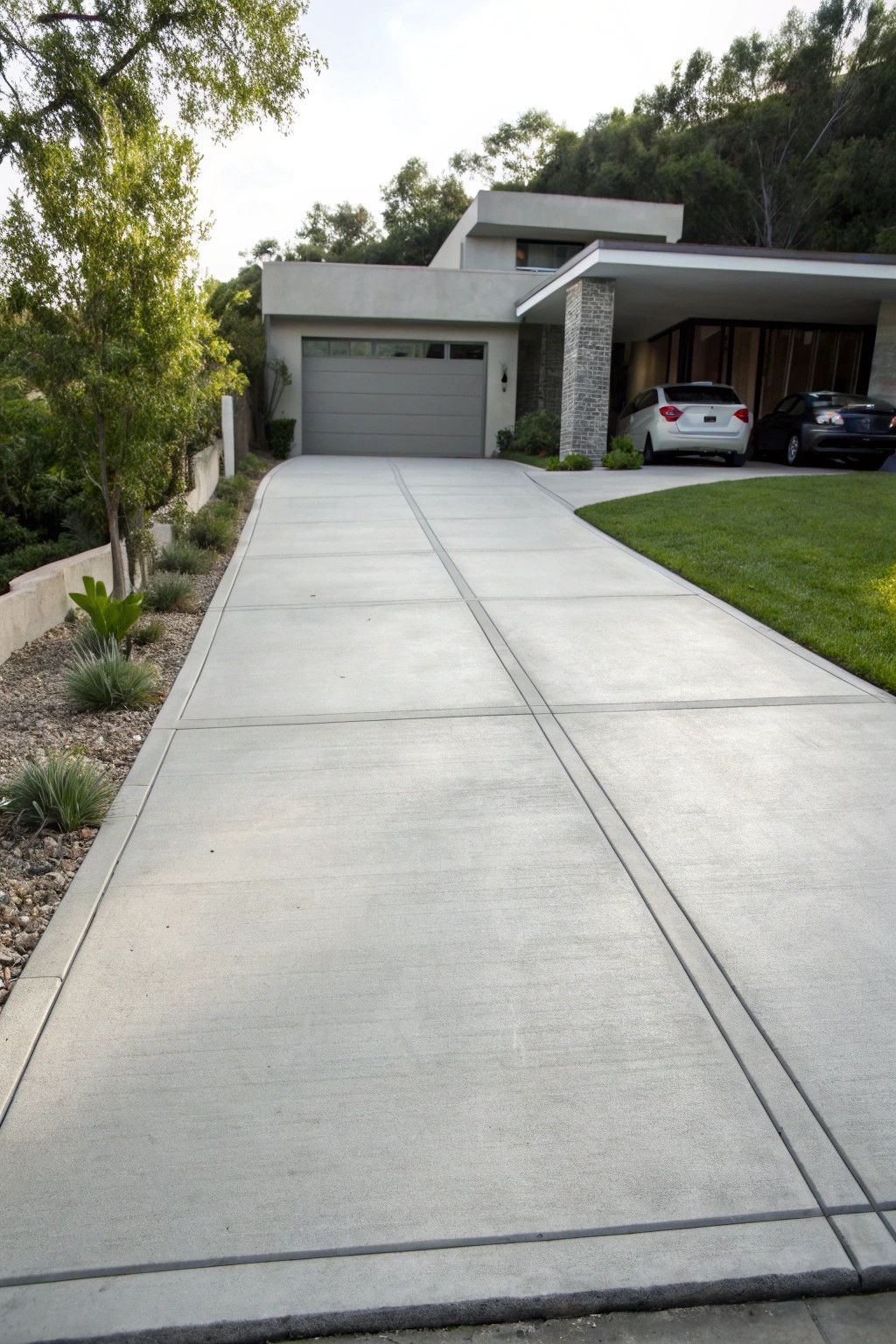 A sleek modern concrete driveway—where minimalist design meets timeless curb appeal.