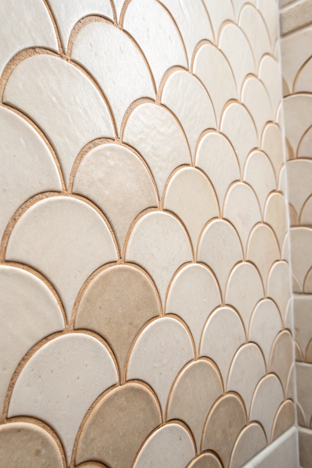 Make a small shower sing with artisanal scallop tiles—unexpected geometry, naturally beautiful.