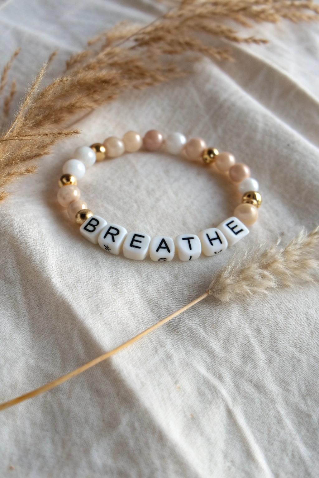 Personalized beauty: a minimalist 'breathe' bracelet crafted for mindful moments.