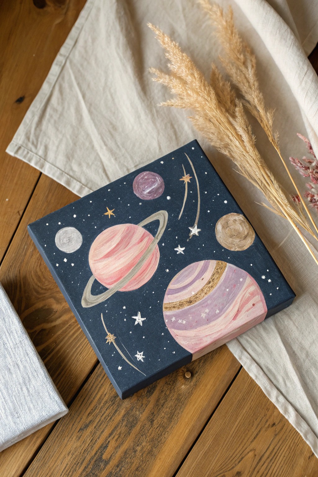 Dreamy mini canvas art: cosmic planets and stars in soft, minimalist hues.