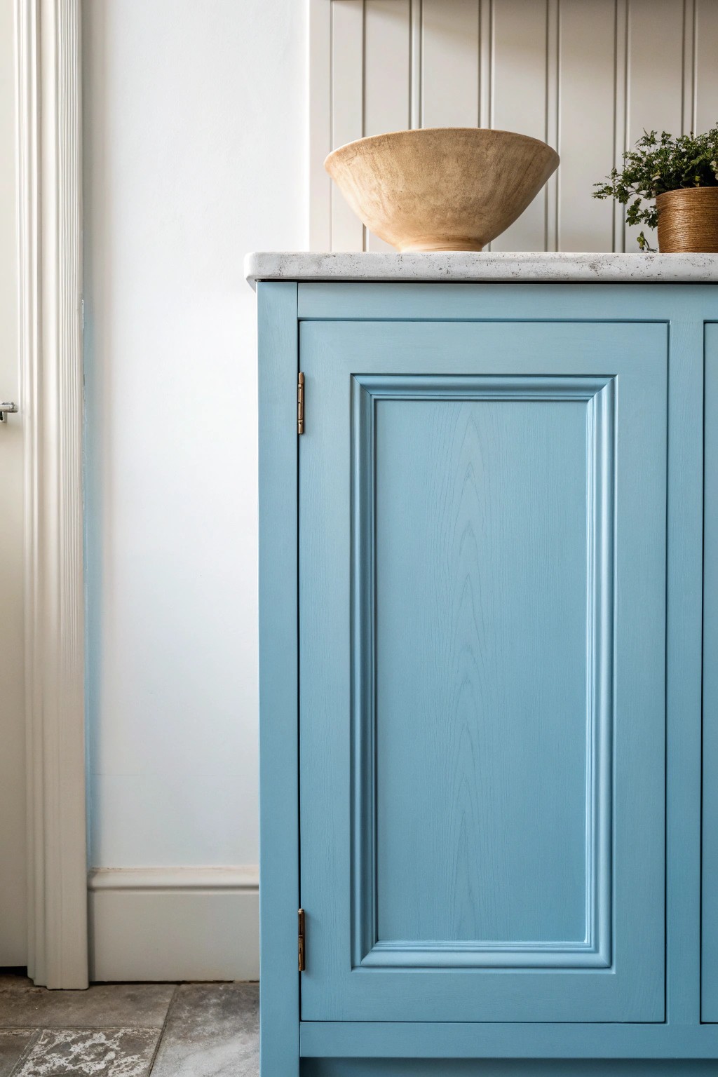 Elevate your kitchen with sky blue cabinets for a fresh, airy charm.