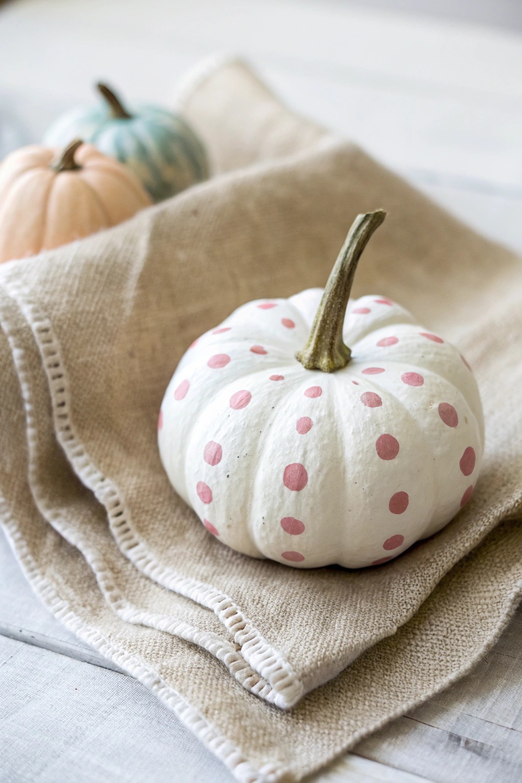 Sweet simplicity: a pastel polka dot pumpkin for effortless autumn charm.